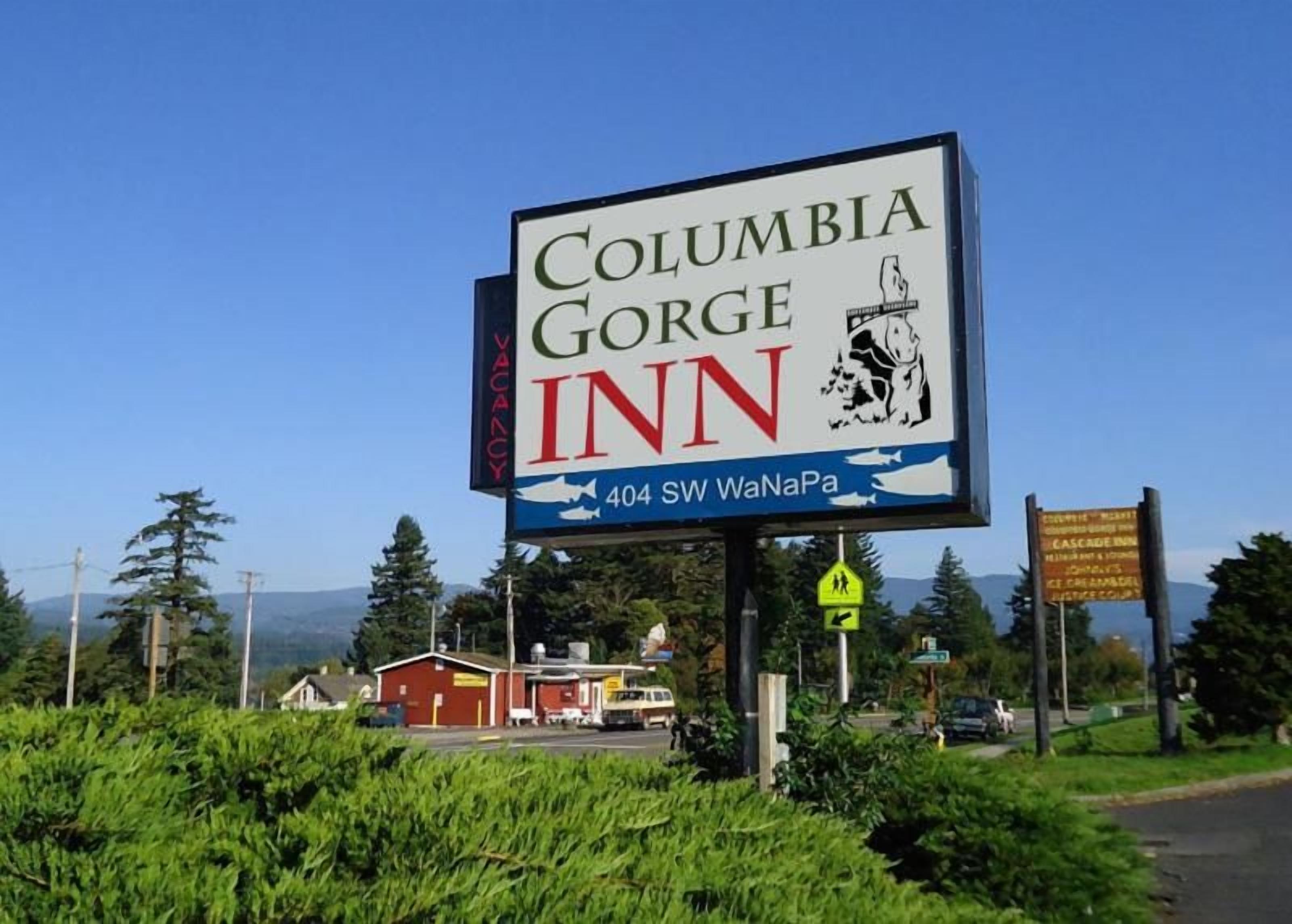 A sign for Columbia Gorge Inn with a mountain illustration and a phone number.