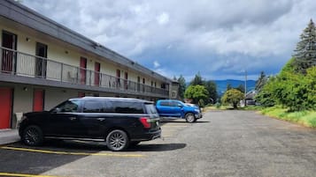 Un estacionamiento con un edificio al fondo.