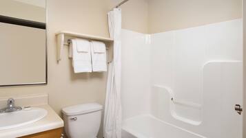 A bathroom with a toilet, sink, and bathtub.
