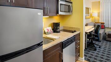 A compact kitchen with a refrigerator, microwave, and coffee maker.