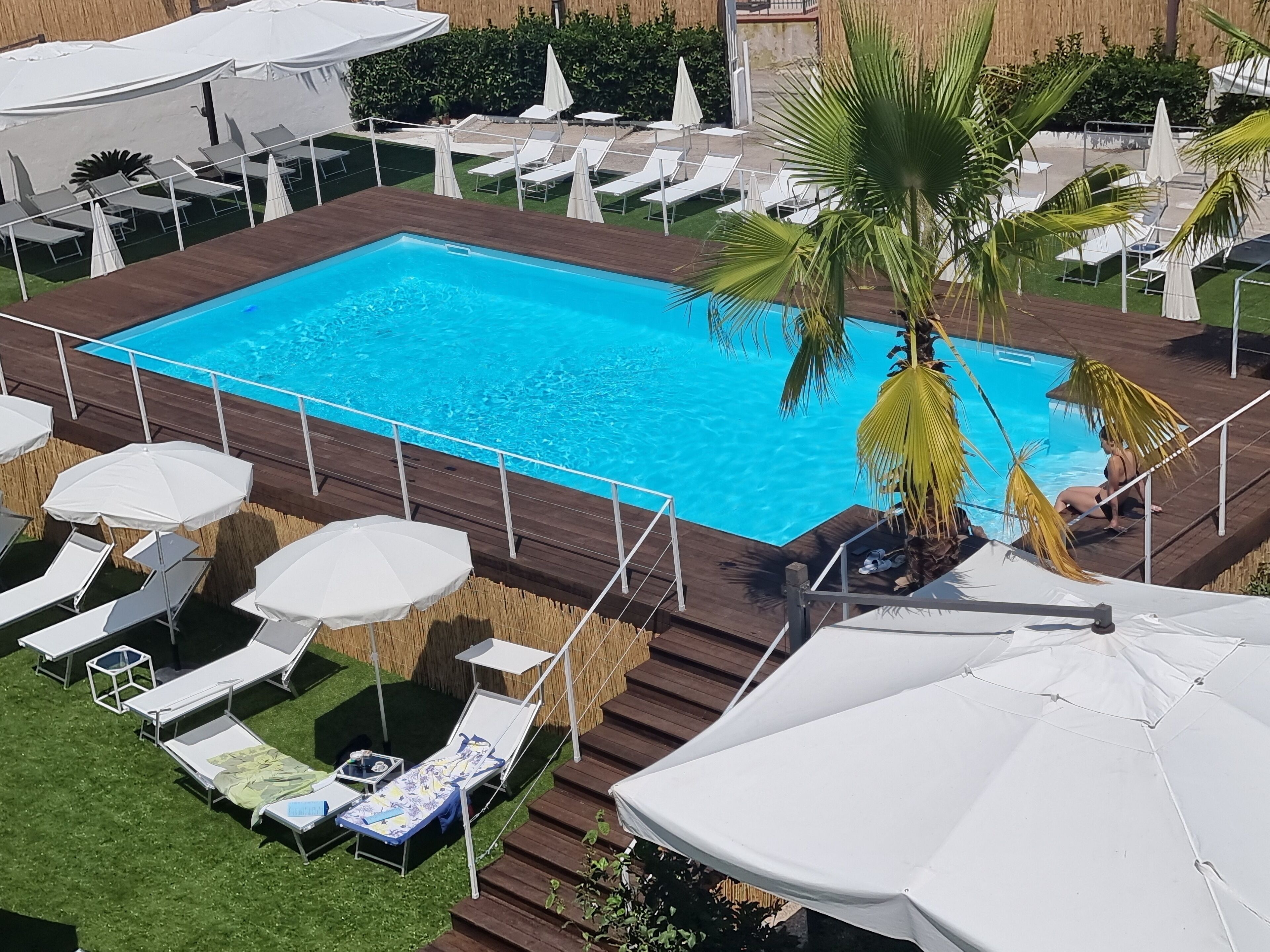 Seasonal outdoor pool, open 10:00 AM to 6:00 PM, pool umbrellas