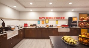 A breakfast area with a sign reading 'HAPPY BREAKFAST STARTS HERE.' - Hampton Inn & Suites Cleveland Mentor (Mentor)