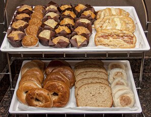 A tray of pastries including bagels and chocolate-covered items. - Hampton Inn & Suites Lebanon (Lebanon)