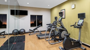 Ett gym med löpband, crosstrainers och träningsbollar.