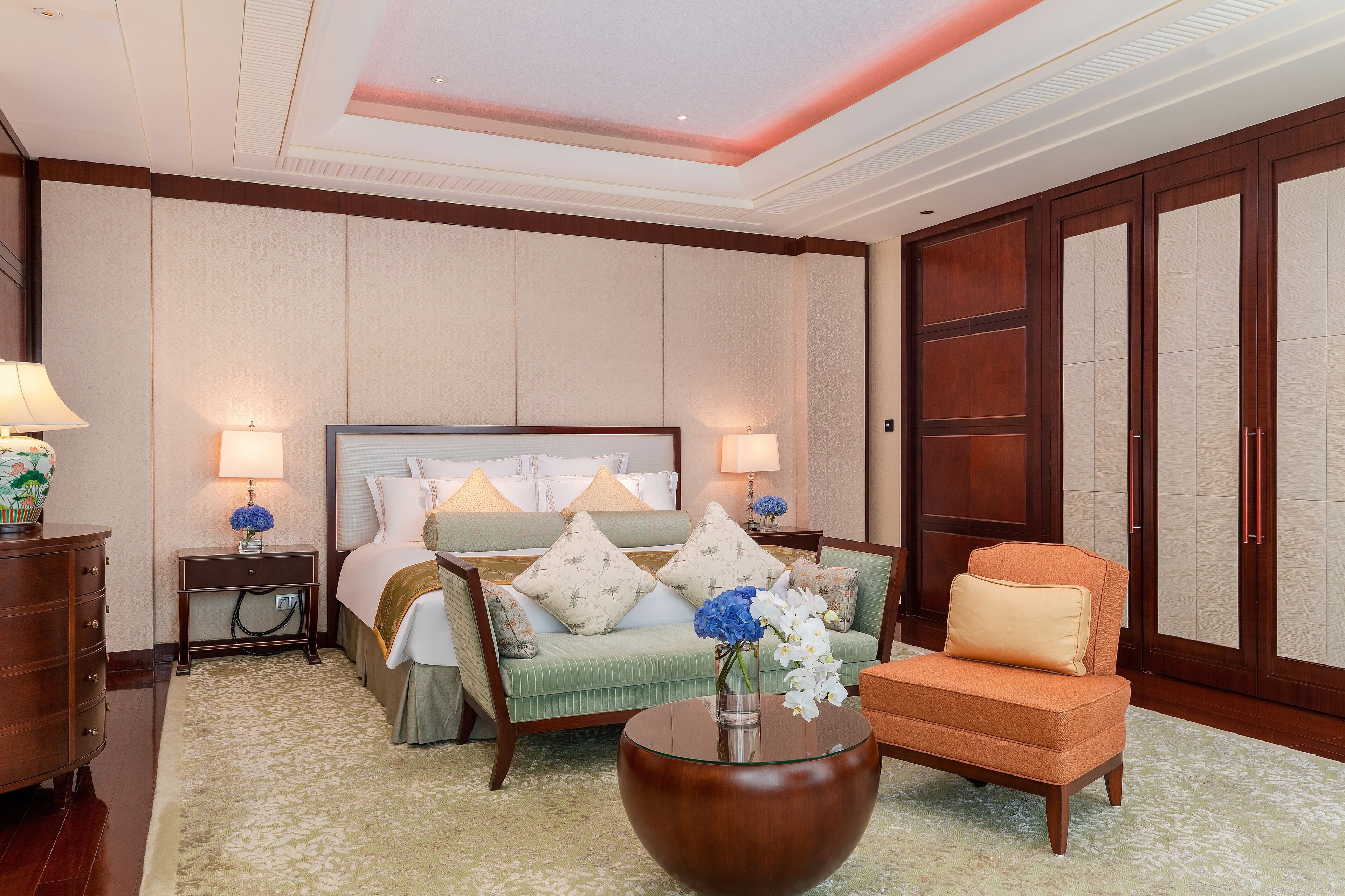 Una habitación de hotel con una cama, un sofá, una mesa de centro y una mesita de noche.