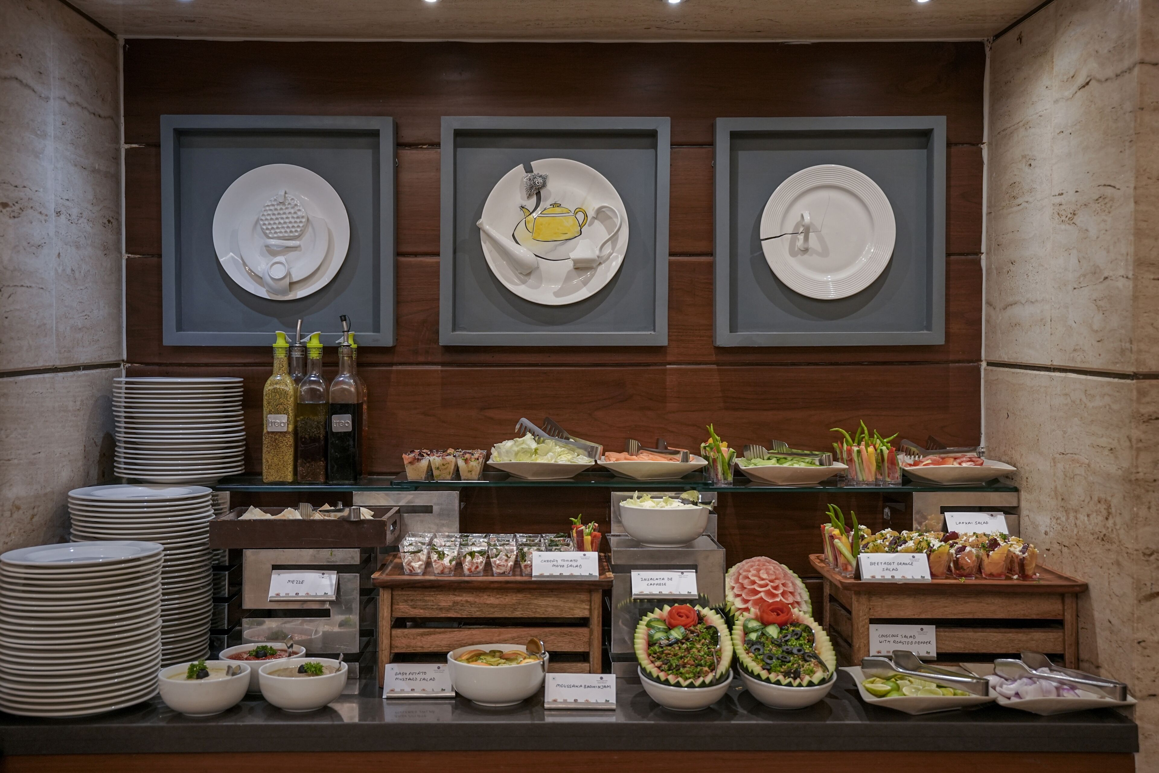 A buffet setup with various food items and condiments.