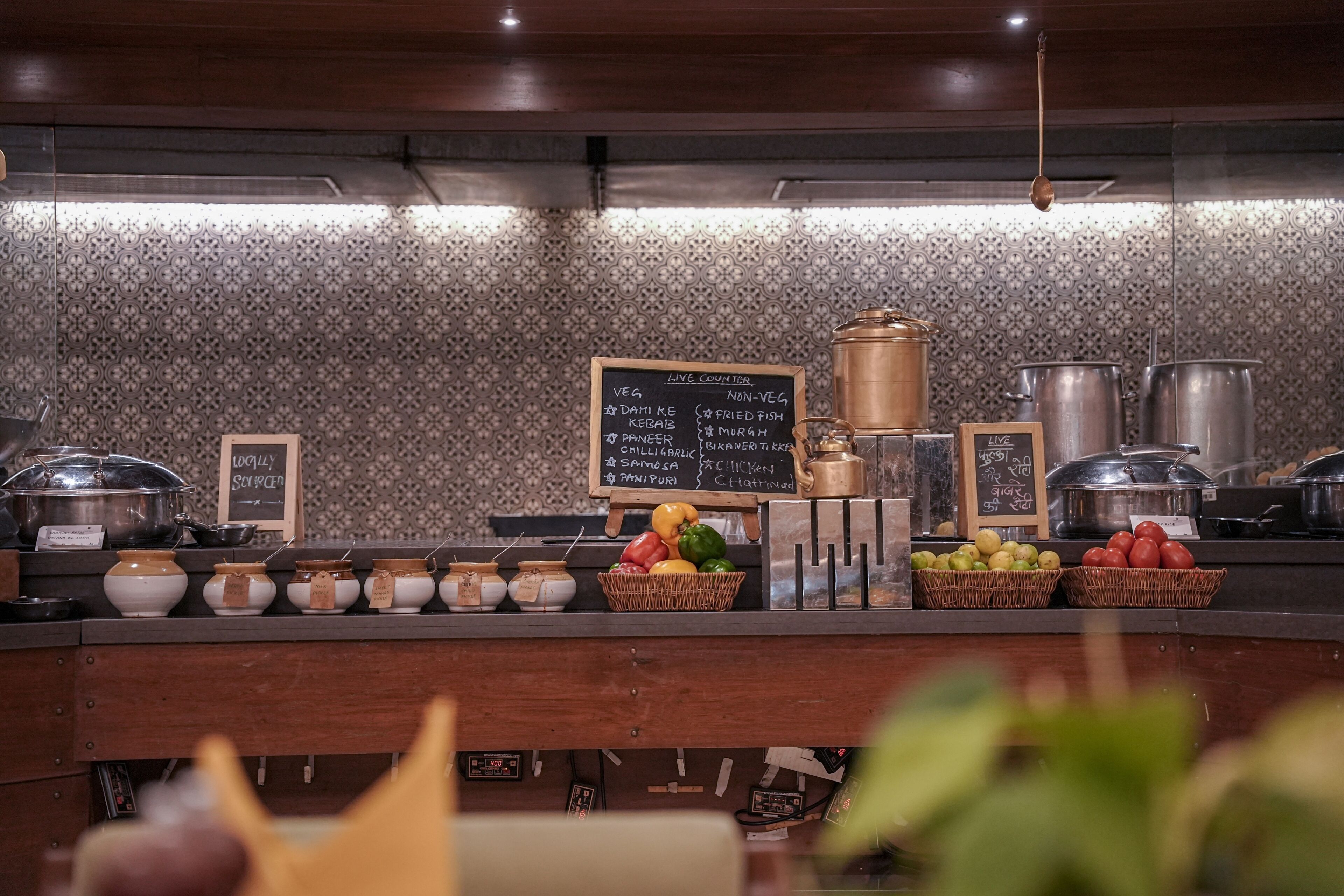 A buffet counter with a variety of food items and live counter options.