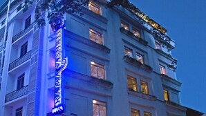A multi-story hotel with a prominent neon sign on the facade. - Ramanashree Brunton (Bengaluru)