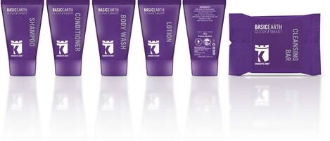 A row of purple skincare products including shampoo, conditioner, body wash, lotion, and a cleansing bar.