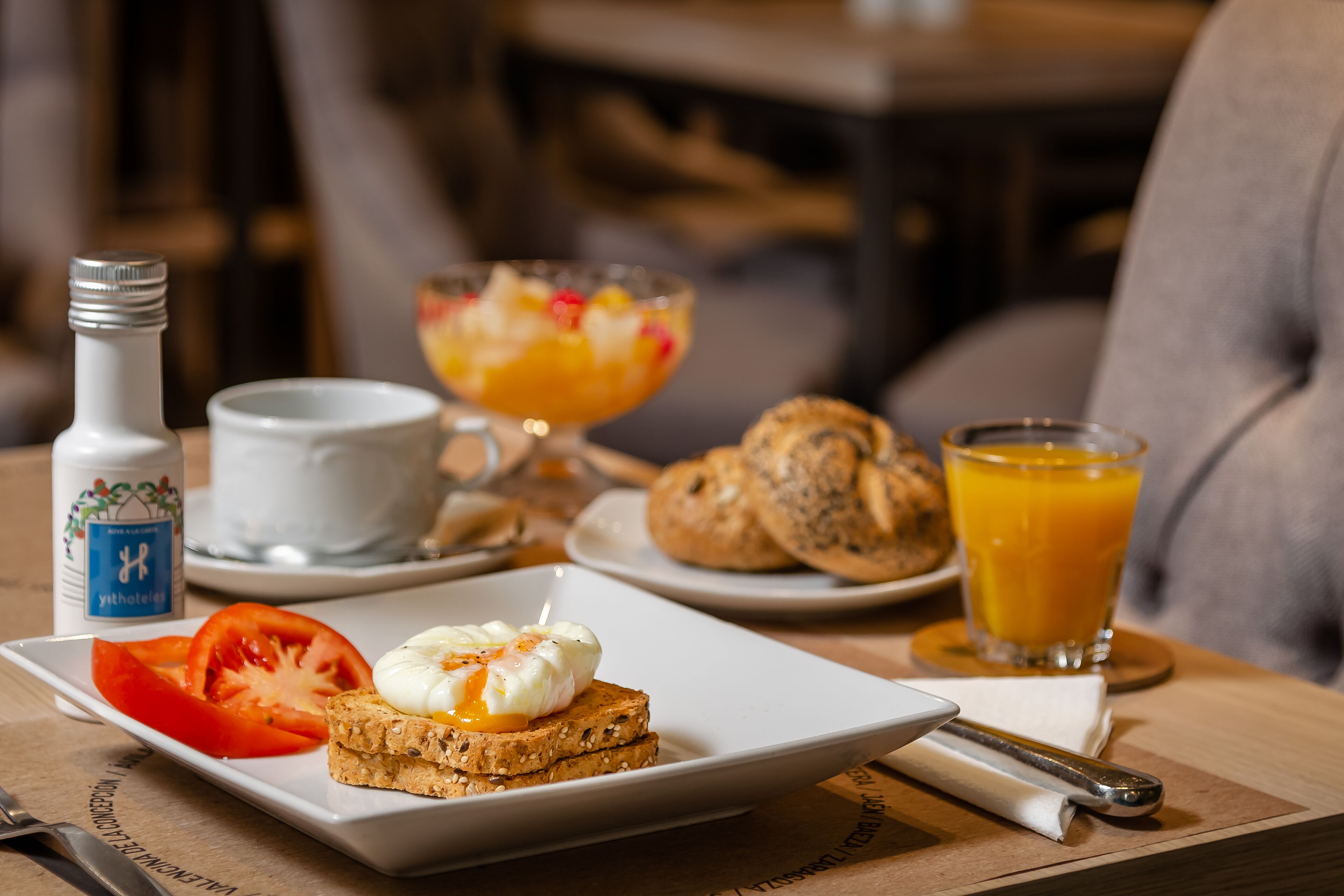 A breakfast setting with toast, tomato, and a beverage.