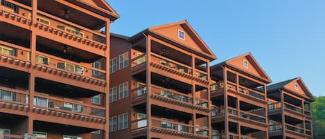 A multi-story hotel with balconies and a stone facade.