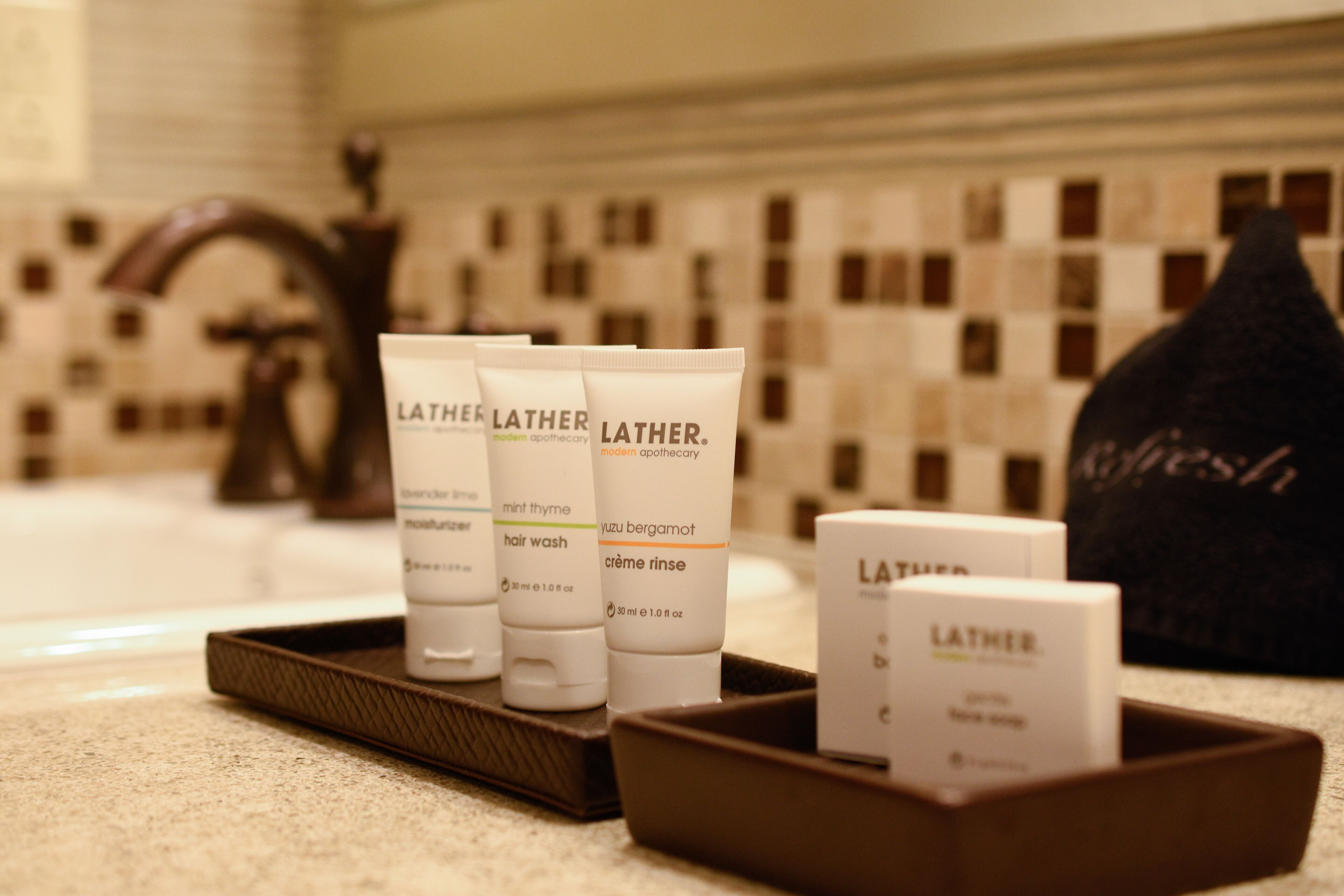 Toiletries in a tray on a bathroom counter.