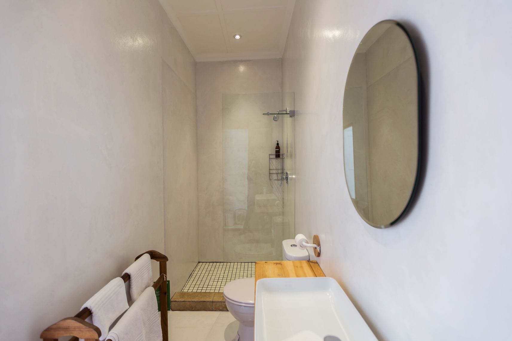 Une salle de bain moderne équipée d’une douche, de toilettes et d’un lavabo.