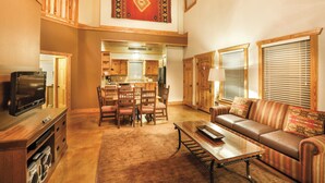 A spacious living area with a dining table, sofa, and a television. - WorldMark New Braunfels (New Braunfels)