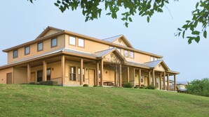 A large, two-story house with a covered porch and a sloped roof. - WorldMark New Braunfels (New Braunfels)
