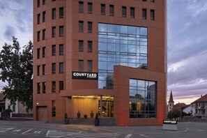 A modern hotel building with a prominent sign reading 'COURTYARD BY MARRIOTT'. - Courtyard by Marriott Downtown Sibiu (Sibiu)