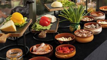 A variety of food items and a statue on a table.