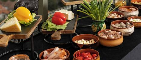 A variety of food items and a statue on a table.