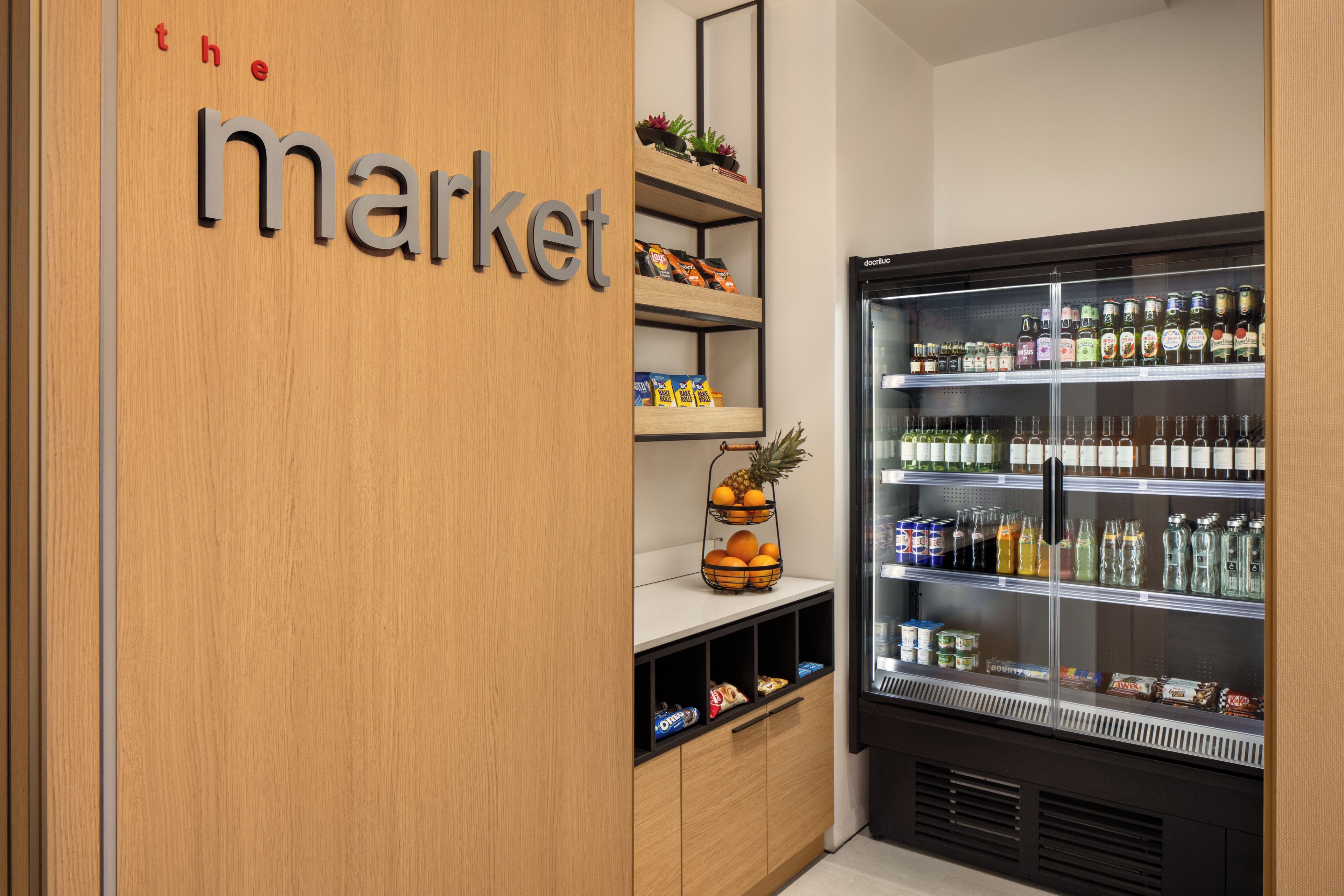 A refrigerated display case with various beverages and snacks.