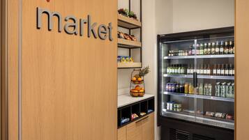 A refrigerated display case with various beverages and snacks.