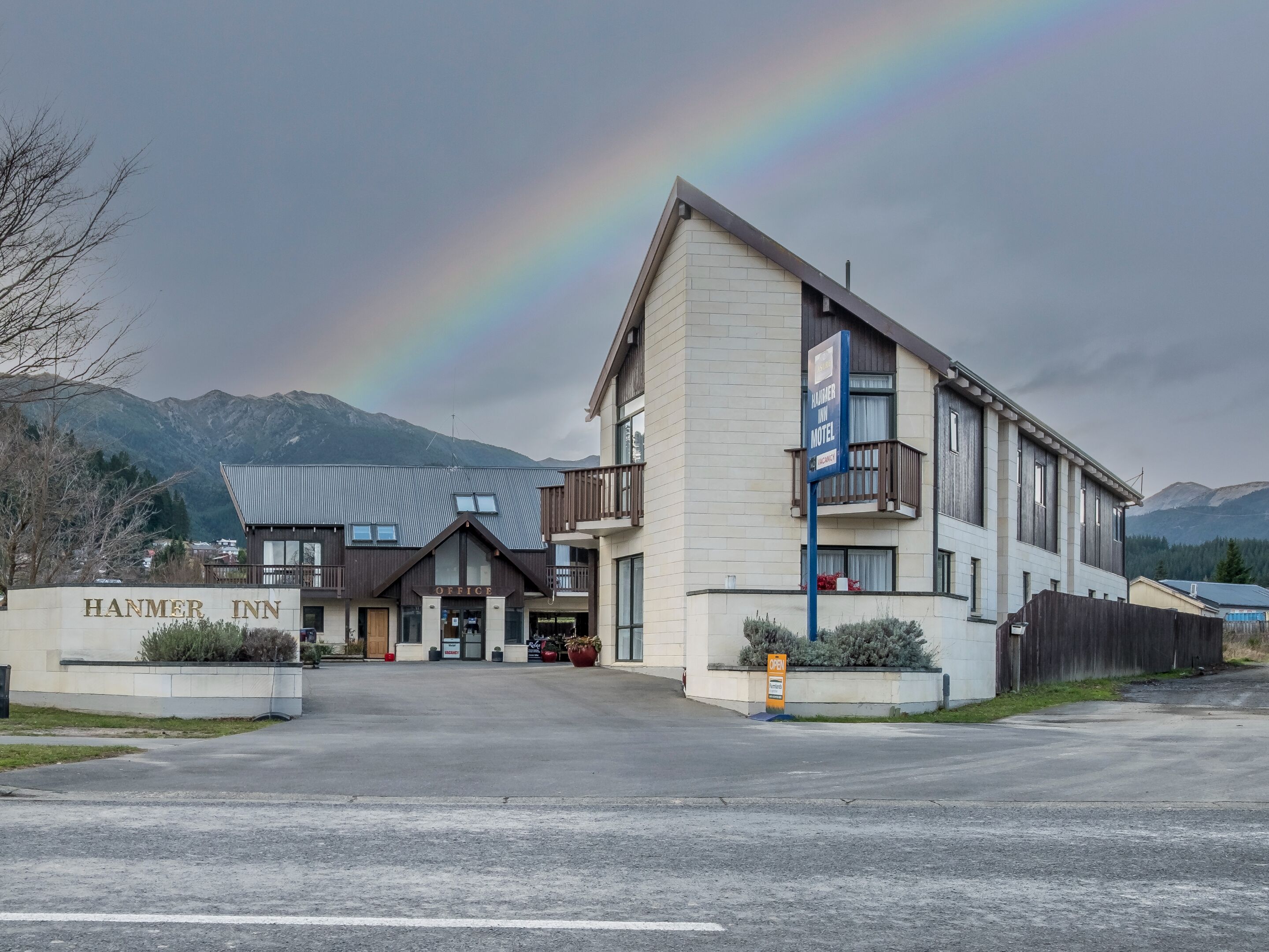 A motel with a sign reading "HANMER INN" and a visible entrance.