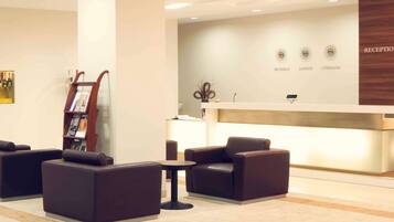 Relax in the stylish reception area with comfortable sofas and a digital display.