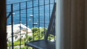 A balcony with a view of the sea, boats, and distant coastline. - Villa Marina Capri - Preferred Hotels & Resorts (Capri)