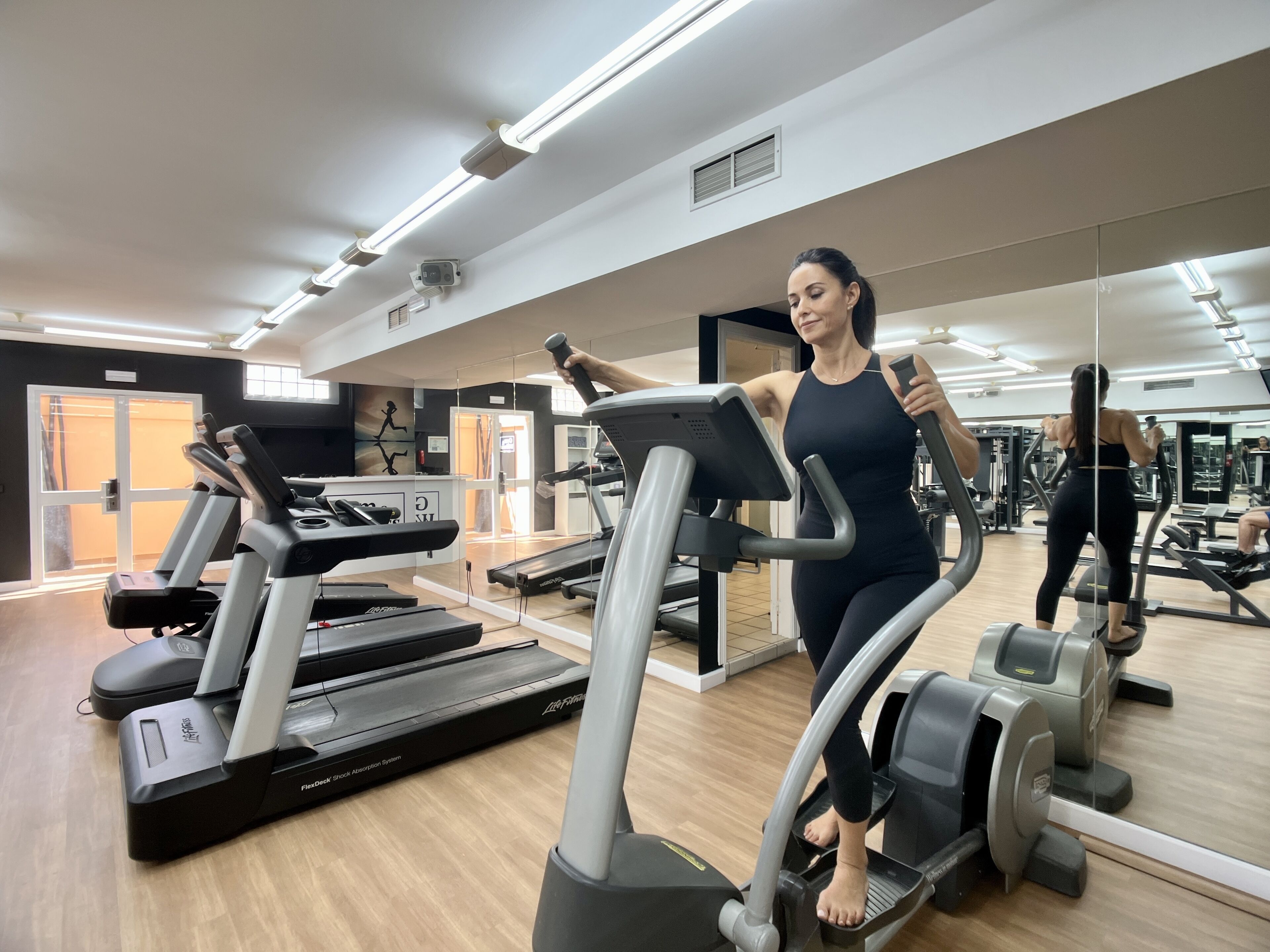 A gym with treadmills, ellipticals, and weight machines.