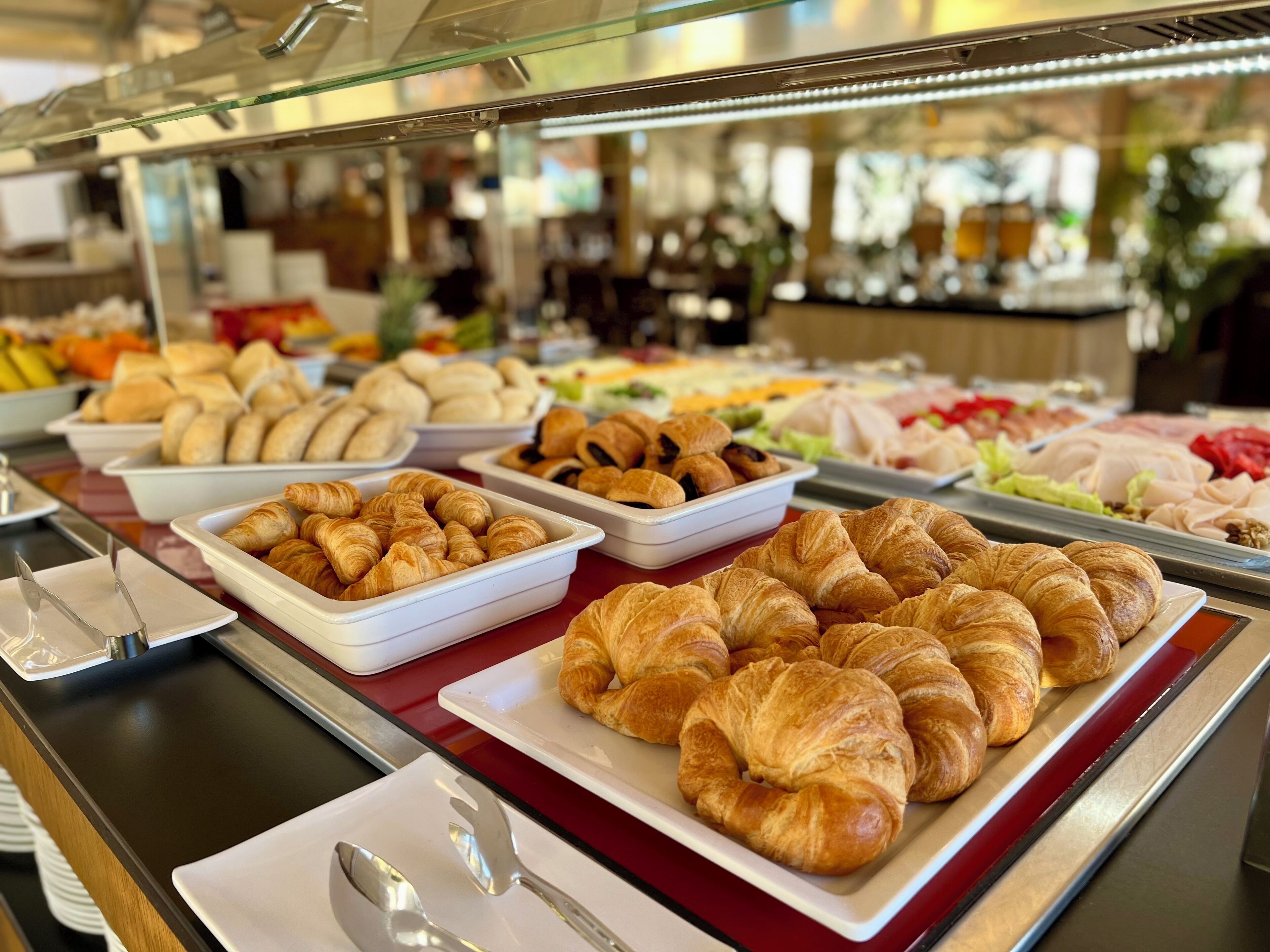 Un buffet proposant une variété de plats, notamment des pâtisseries et des salades.