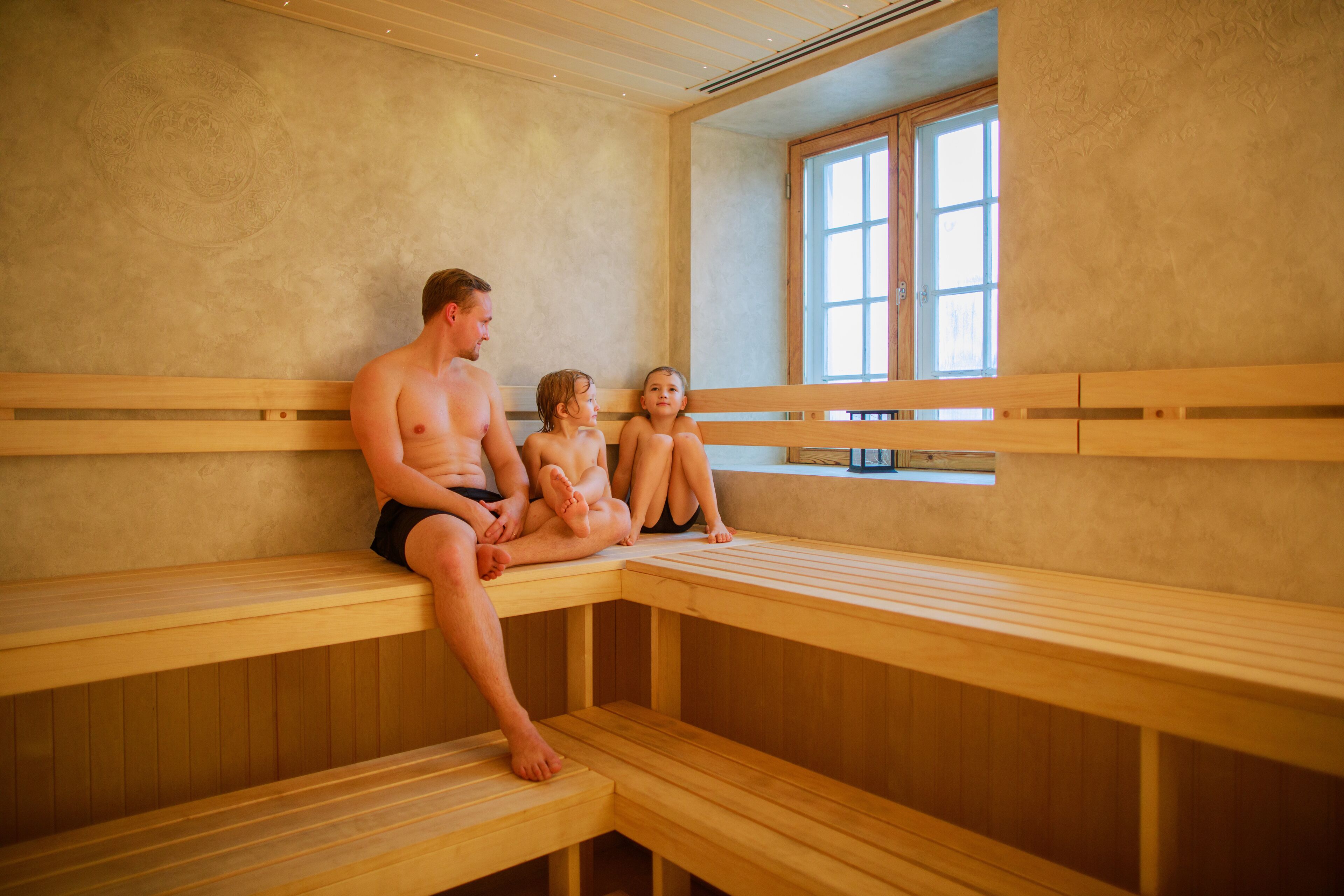 A sauna with wooden benches and a large window.