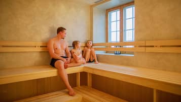 A sauna with wooden benches and a large window.