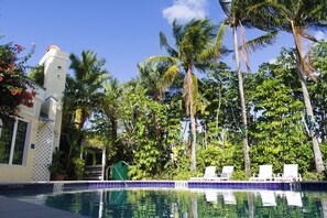 Outdoor pool, pool umbrellas, sun loungers - The Caribbean Court Boutique Hotel (Vero Beach)