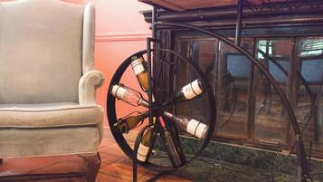A chair and a wine rack with bottles.