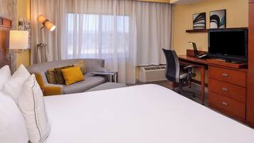 Premium bedding, desk, laptop workspace, blackout curtains