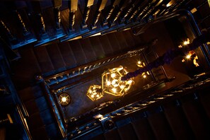 A high-ceilinged staircase with ornate metal railings and a central light fixture. - 11 Cadogan Gardens and The Apartments (London)