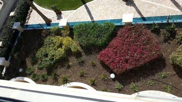 An aerial view of a landscaped area with various plants and a stone pathway.