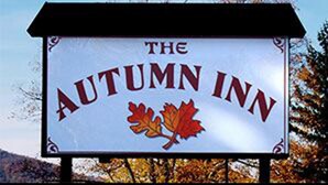 A sign for The Autumn Inn with a maple leaf design. - The Autumn Inn (Bennington)