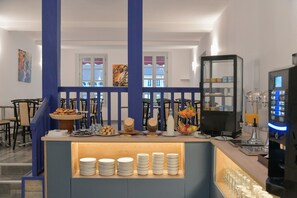 A breakfast bar with plates, bowls, and a coffee machine.