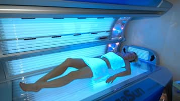 Eine Solariumliege mit einer Person, beschriftet mit "MegaSun".