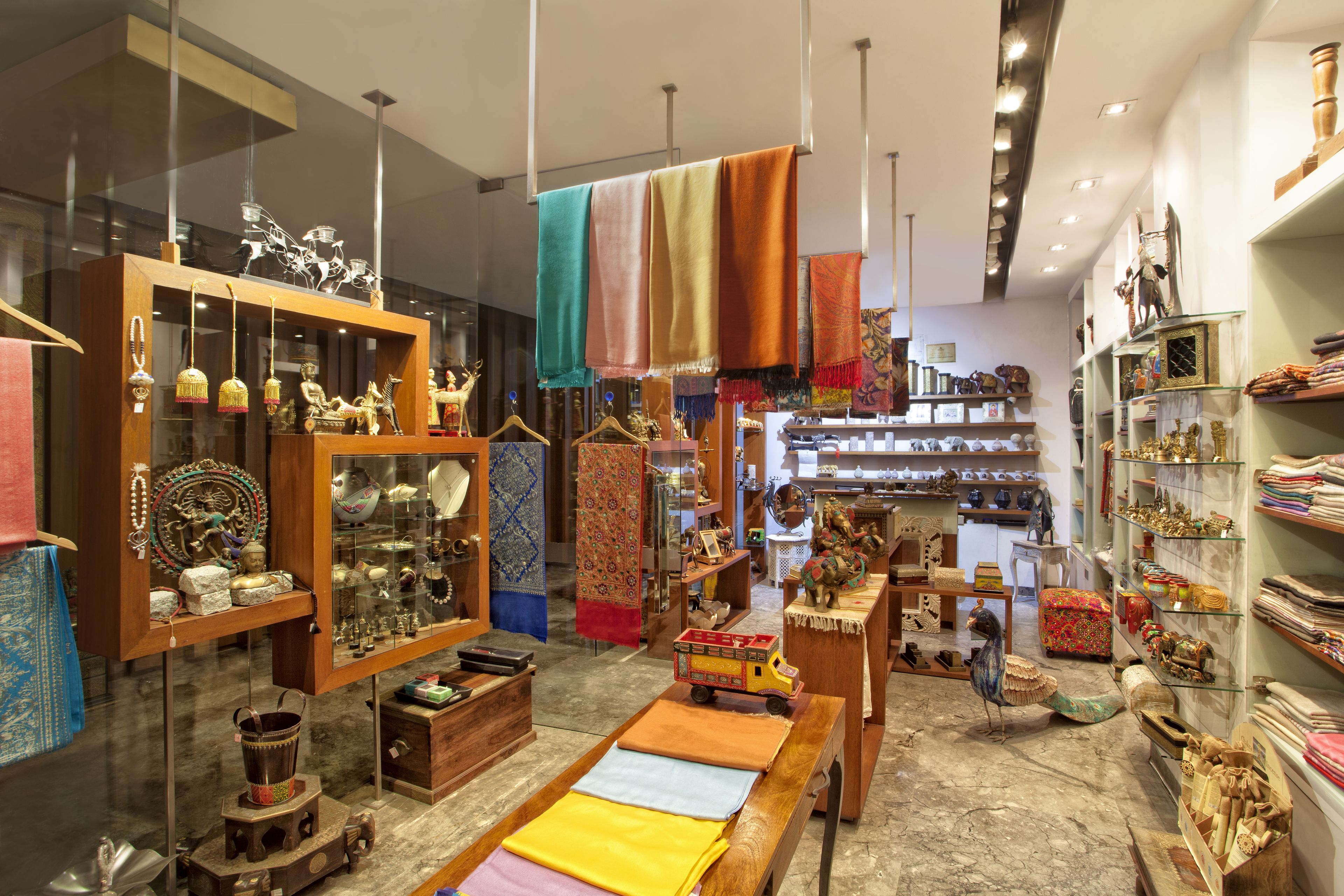 A well-lit store with various textiles and decorative items on display.