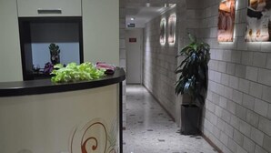A hotel reception area with a reception desk labeled "SpaSan." - Villa Natali (Chisinau)
