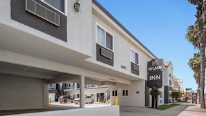 A modern building with a sign for 'Hyland Inn' and a clear area marked 'Clearance 8'.