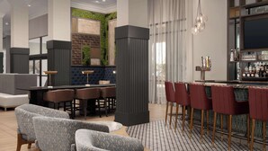 A modern bar area with a bar counter, seating, and a television. - Hilton Phoenix Chandler (Chandler)
