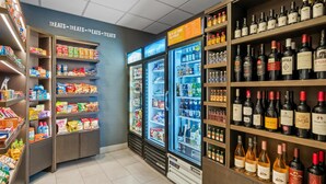 A grocery store with shelves stocked with snacks, beverages, and wine. - Hampton Inn & Suites Detroit-Canton (Canton)