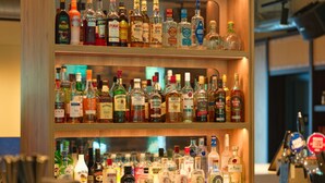 A bar with shelves of various liquor bottles. - B&B HOTEL Warrington (Warrington)