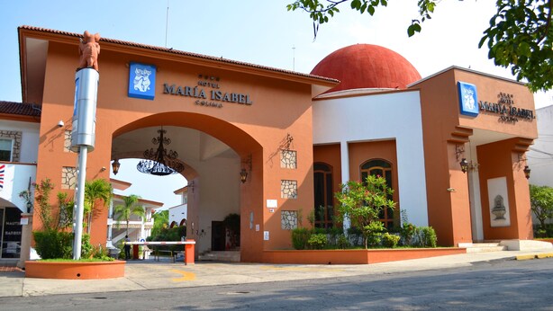 The entrance to Maria Isabel Hotel with a prominent archway and a red dome.