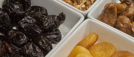 Three white rectangular containers with dried fruits.