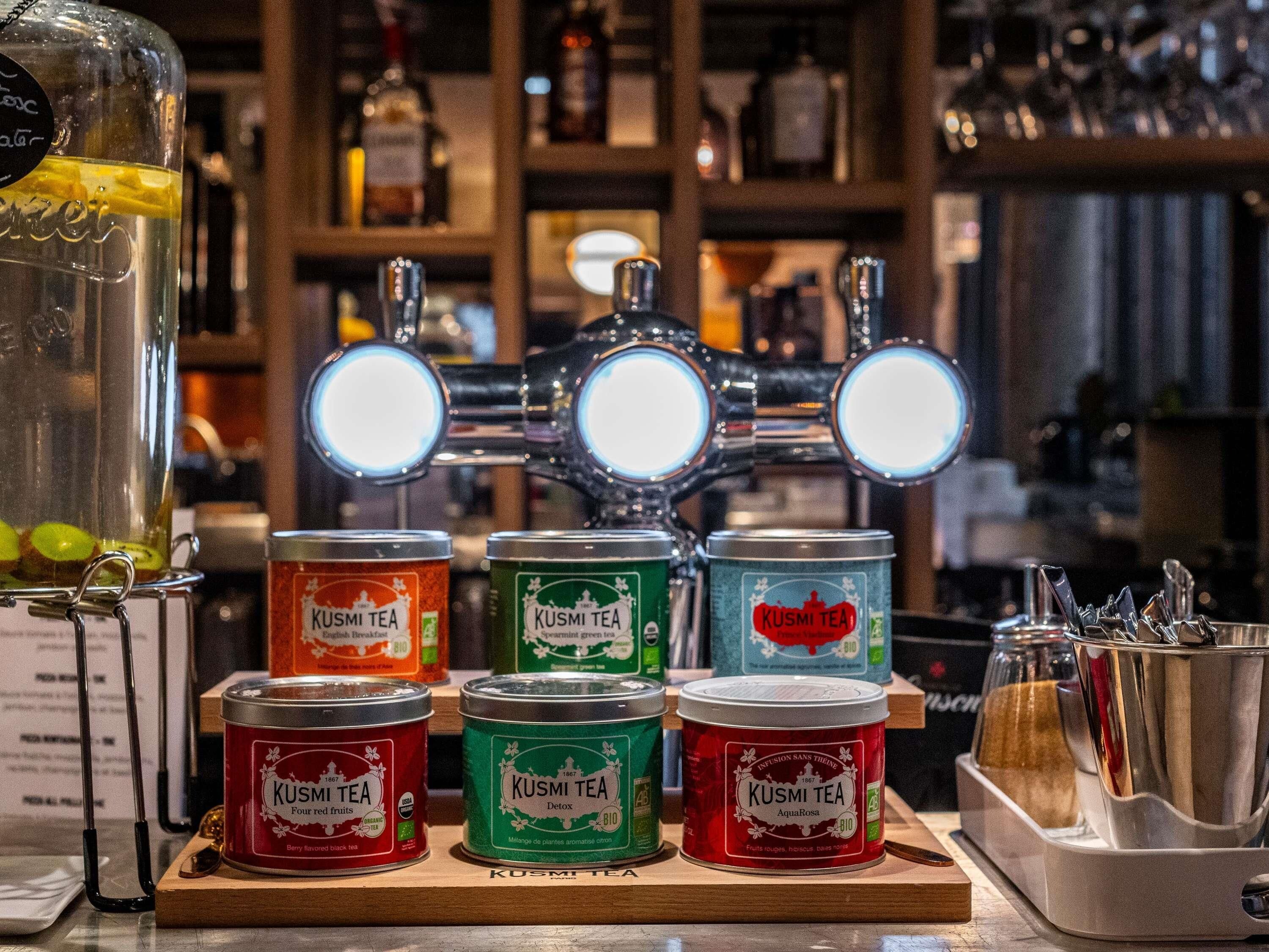 A bar setting with a tap and various canned beverages.