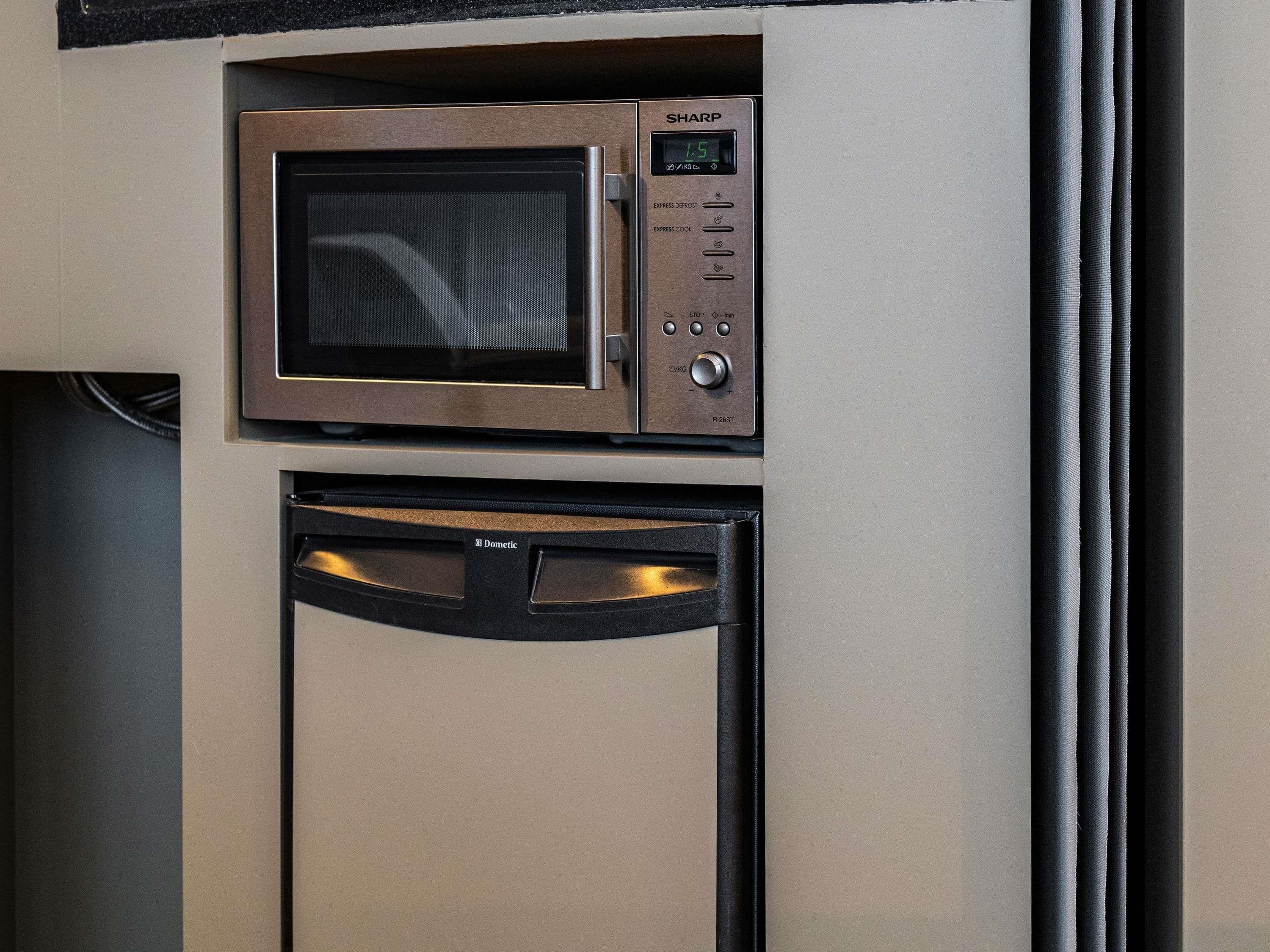 A microwave and dishwasher built into a cabinet.