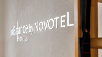 A wall with the text "In Balance by Novotel Fitness".